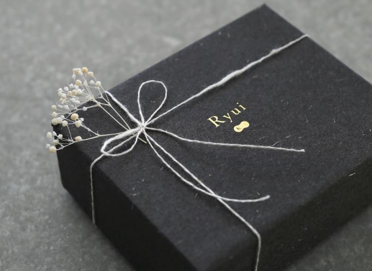 Box wrapped with white branches and white string